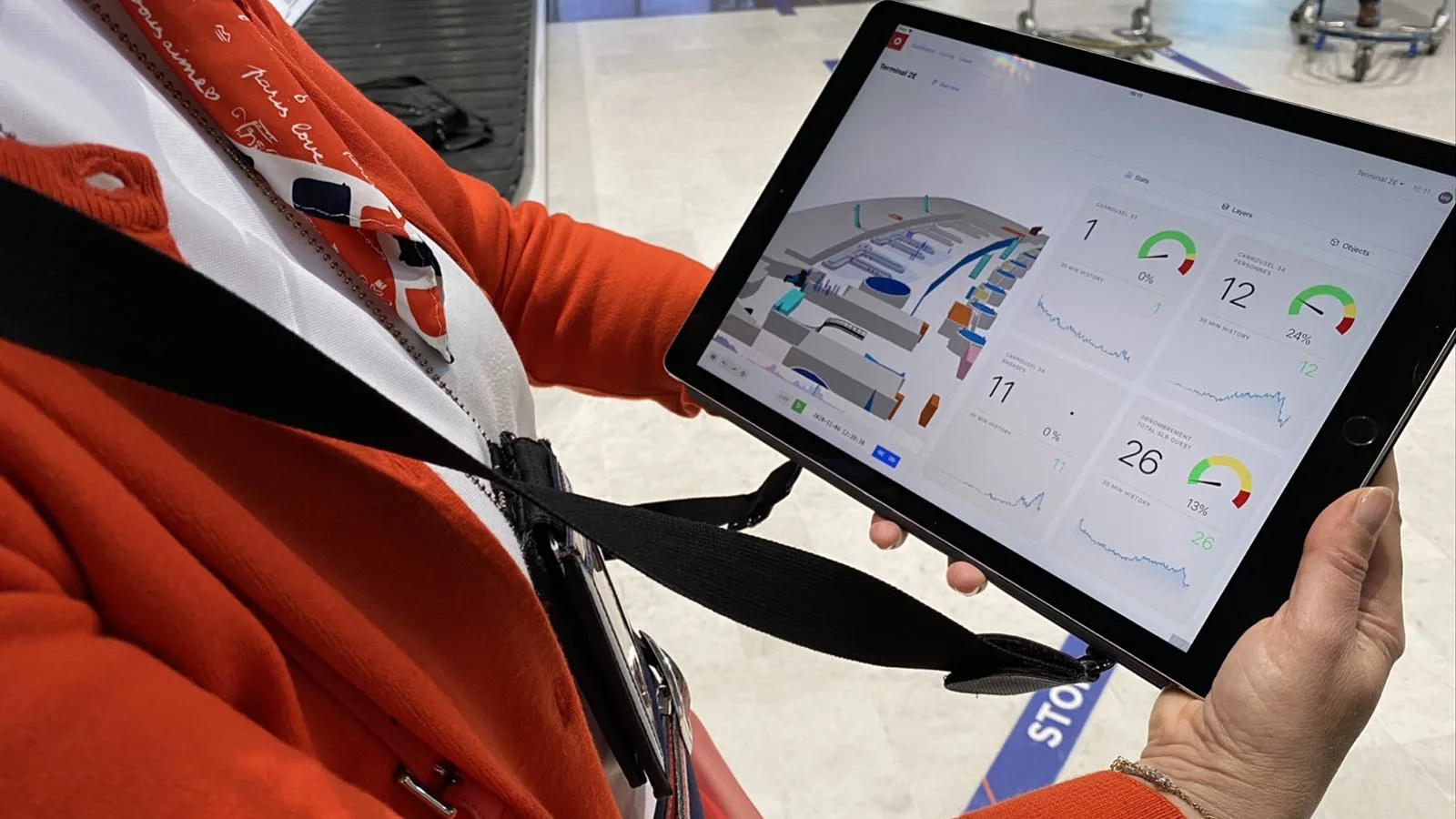 Airport operations employee demonstrating Outsight's dashboard for passenger flow journey